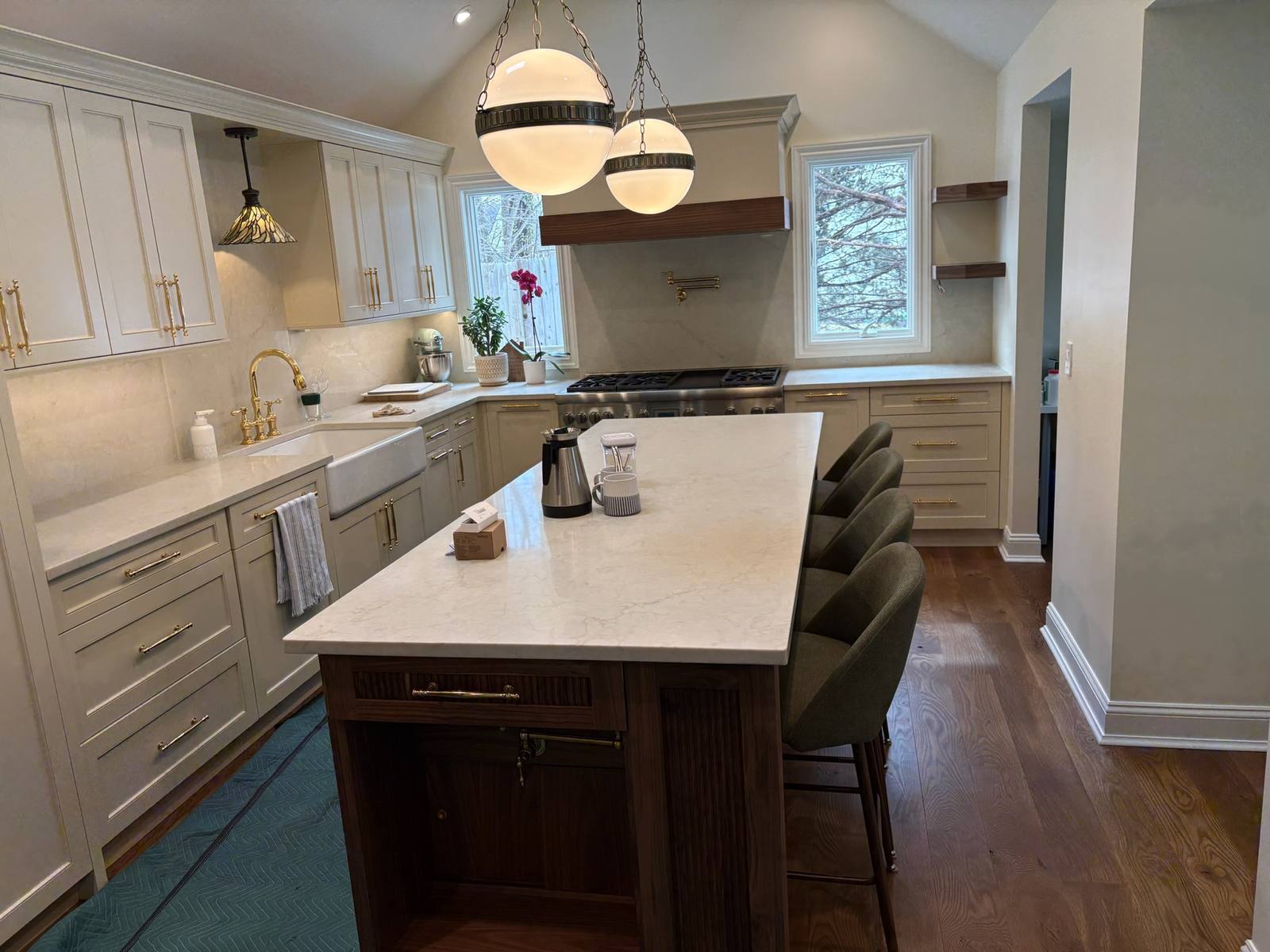 Finished: Walnut island with a quartz top and stools, painted cabinets and two globe pendants.