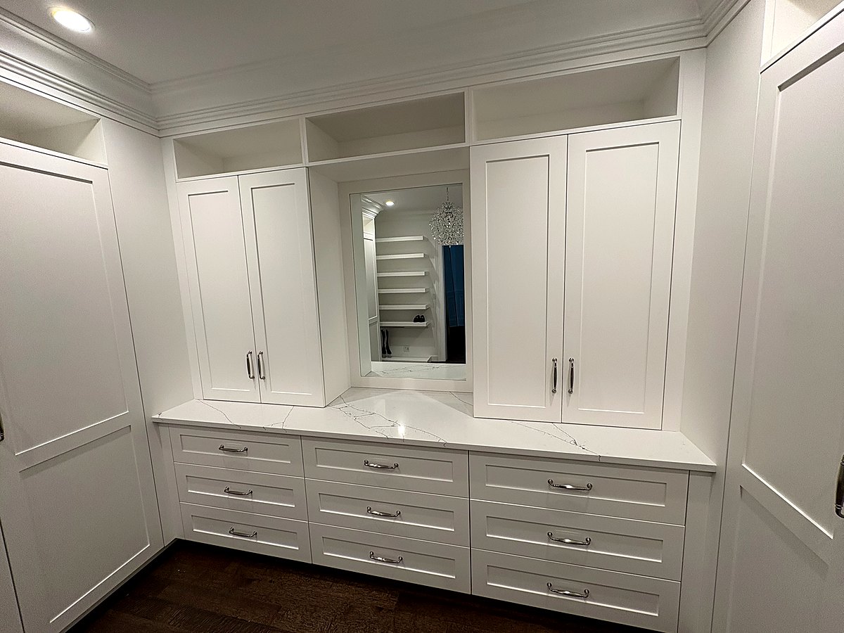 Built-in dresser with a mirrored niche and paneled wardrobe doors
