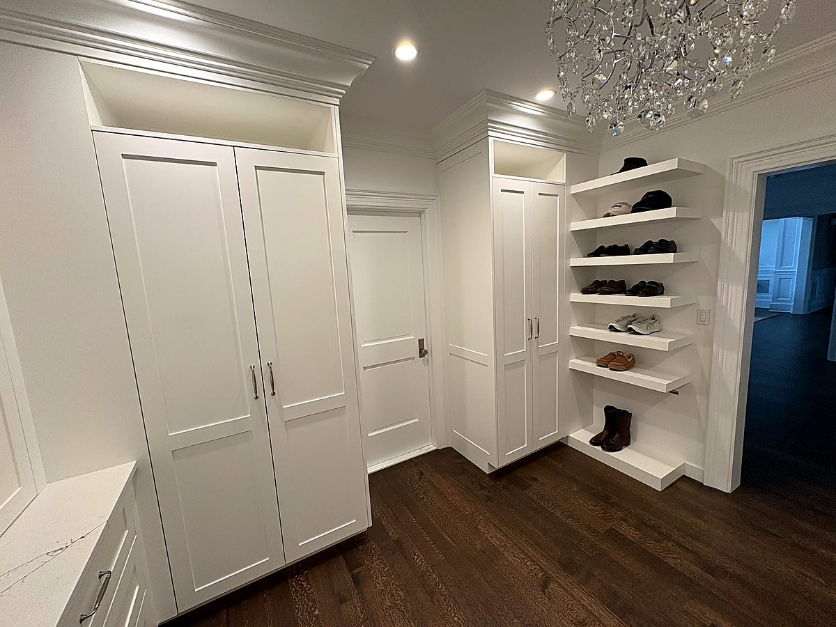Custom closet with angled shoe shelving and full height wardrobes