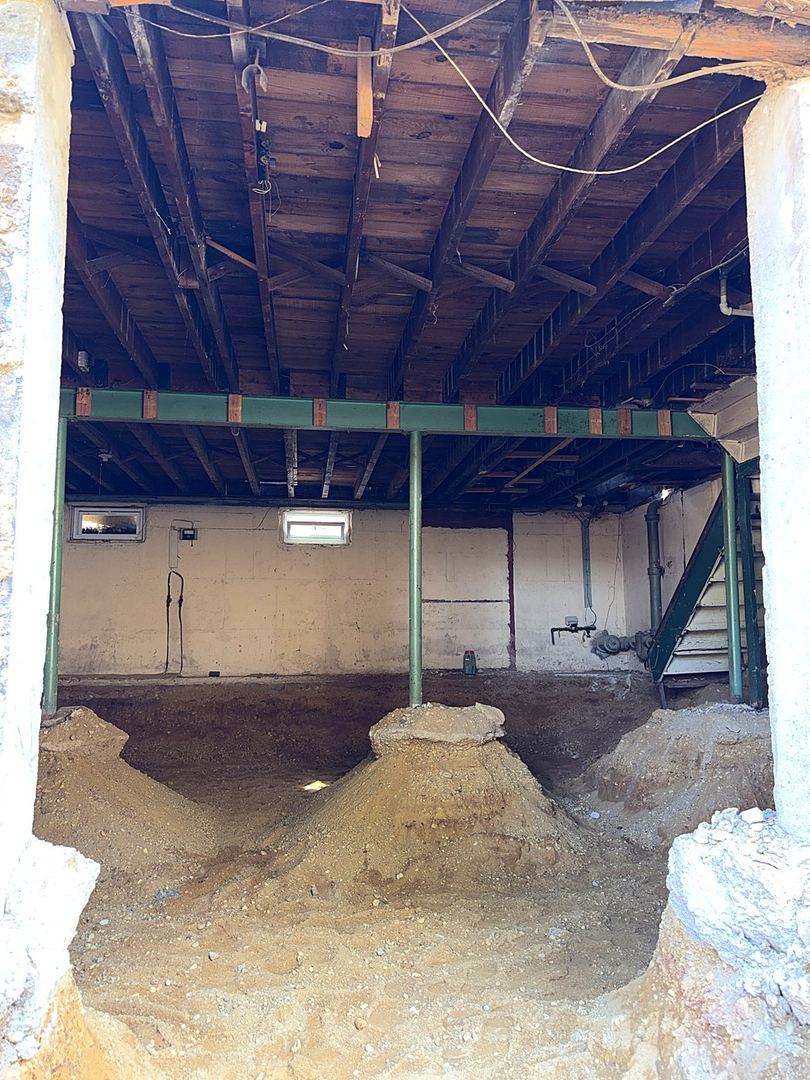 New steel framing supporting the structure over the excavated basement
