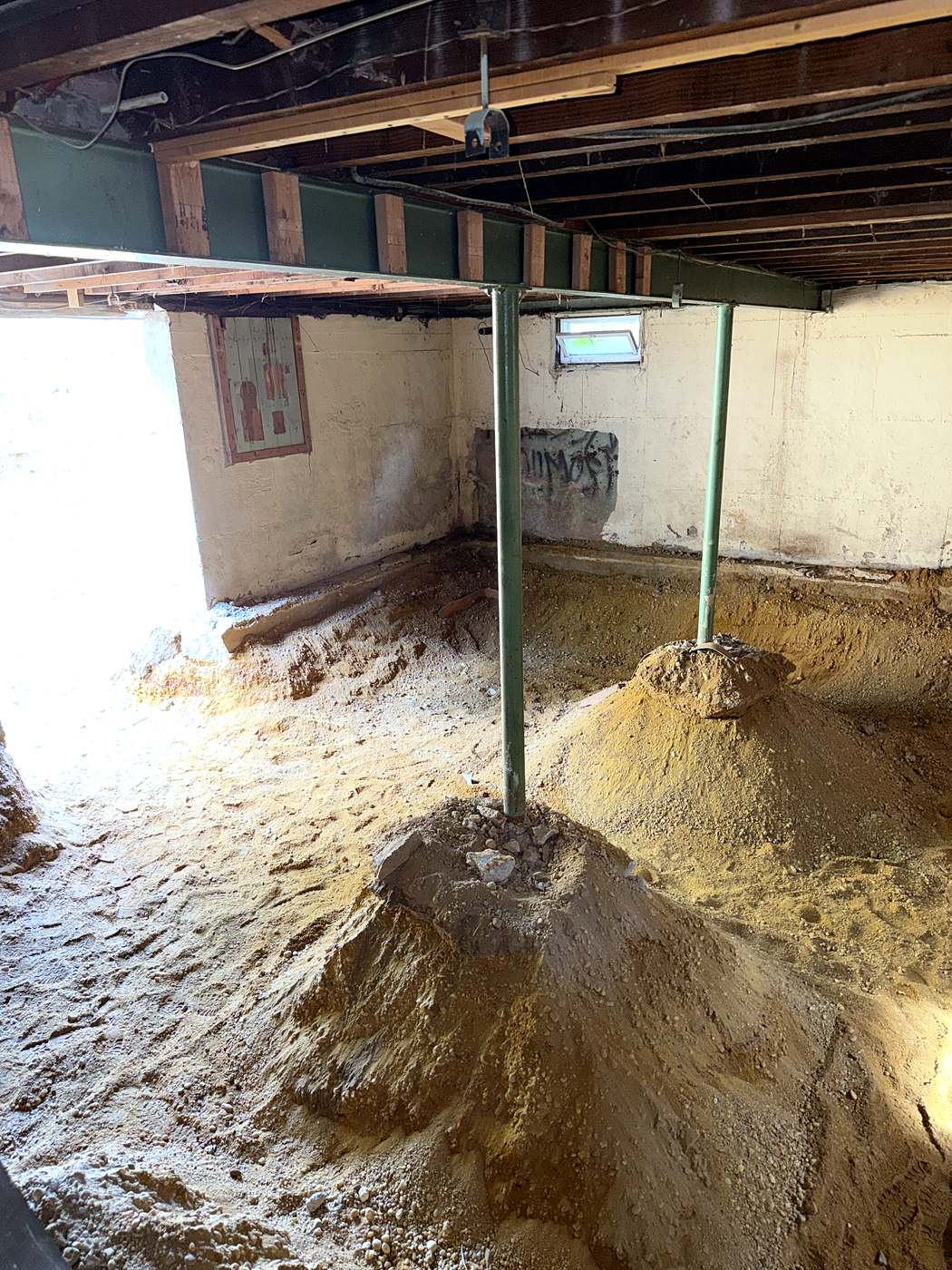 Steel column carrying the house above the soil excavated out from under the original foundation