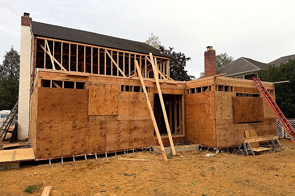 Addition walls sheathed with ladders set for the second floor framing