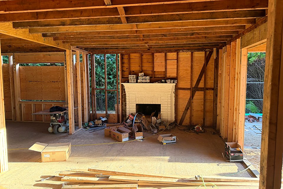 Open first floor framing looking toward the fireplace wall