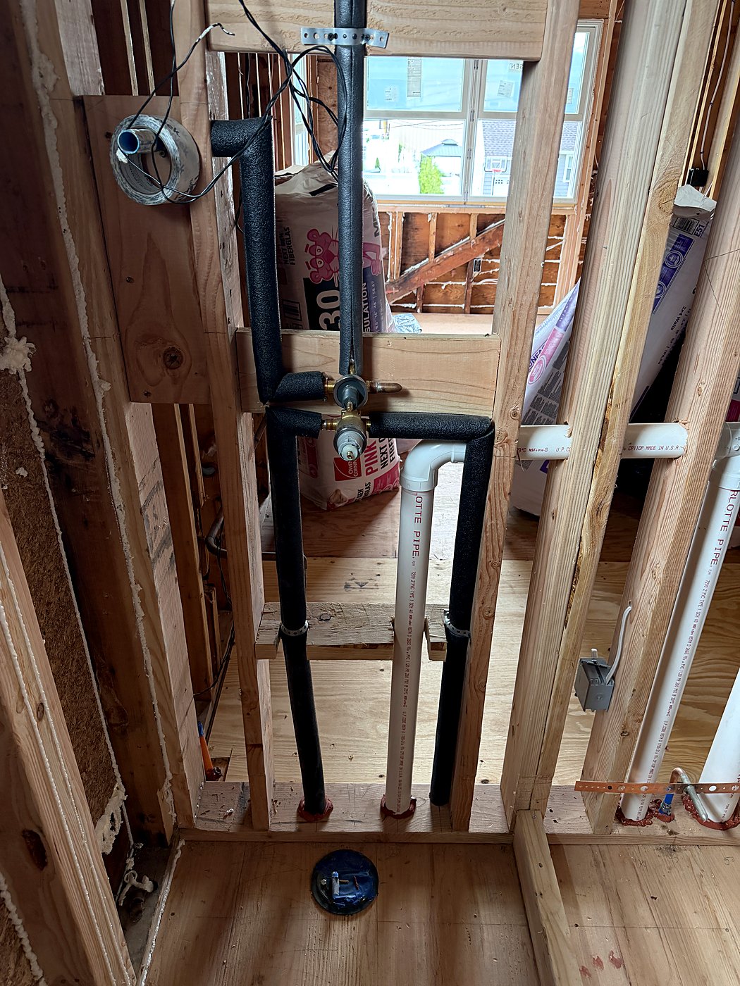 Plumbing rough-in for the new bathroom between the studs