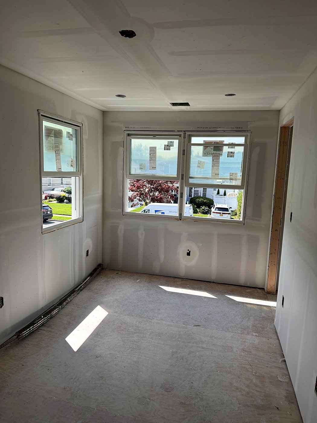 Hallway with drywall hung and taped, ready for finishing