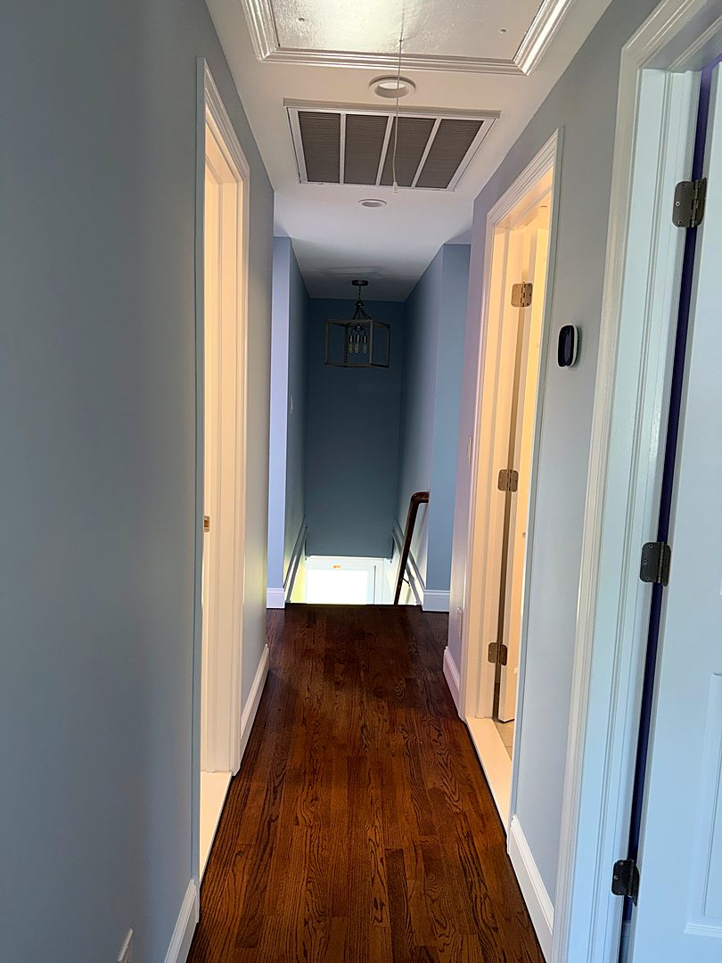 Finished upstairs hallway with refinished hardwood floors and new doors