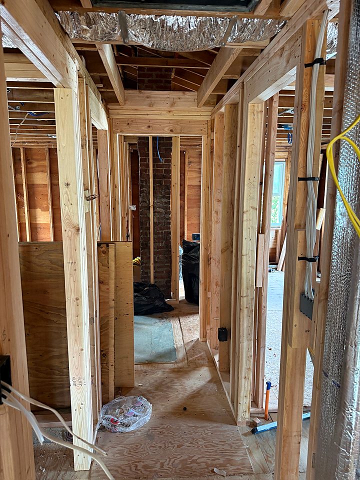 New interior framing for the hall and bath with wiring run through the studs