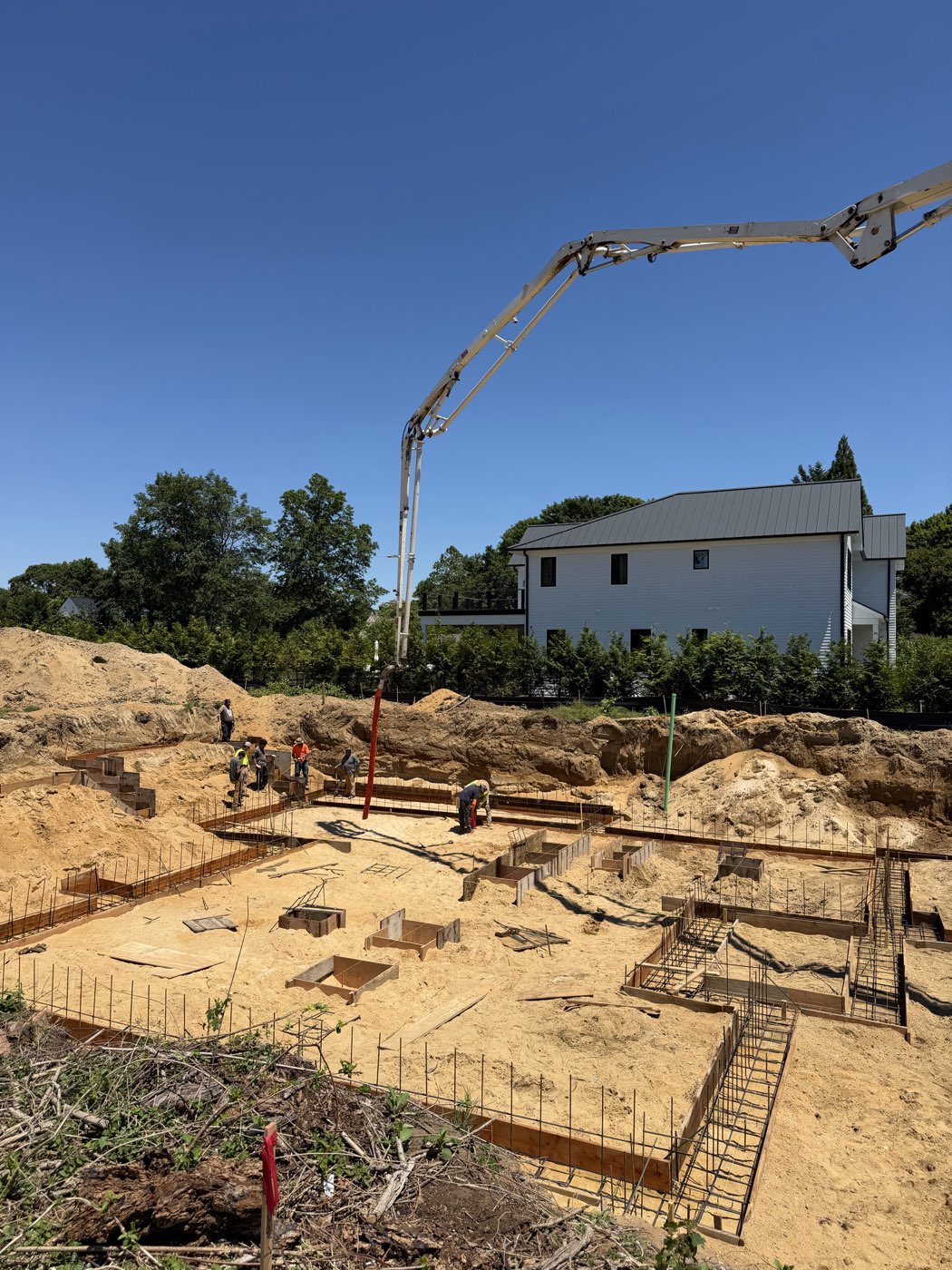 Pump boom positioned above the rebar cages and formwork before the pour