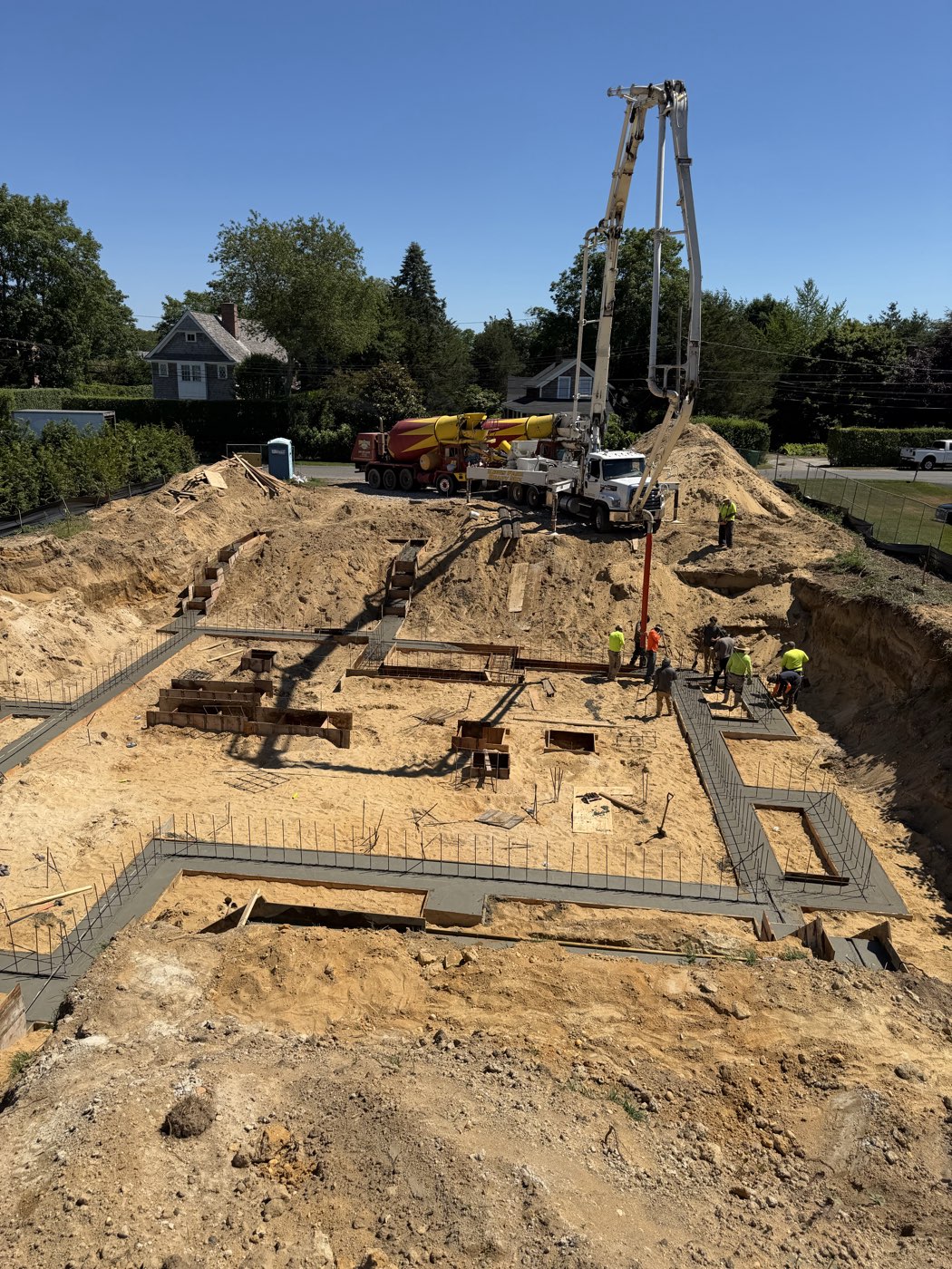 Poured foundation walls dividing the interior rooms of the new custom home