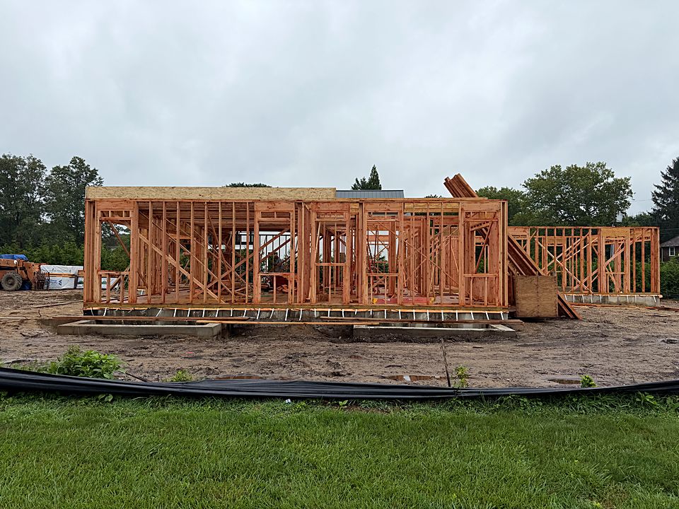 First floor walls framed on the new foundation of a custom home