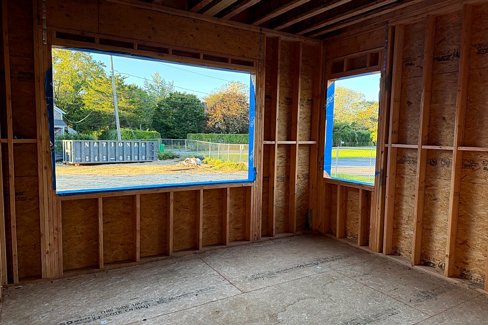 Large picture window openings framed in a first floor room