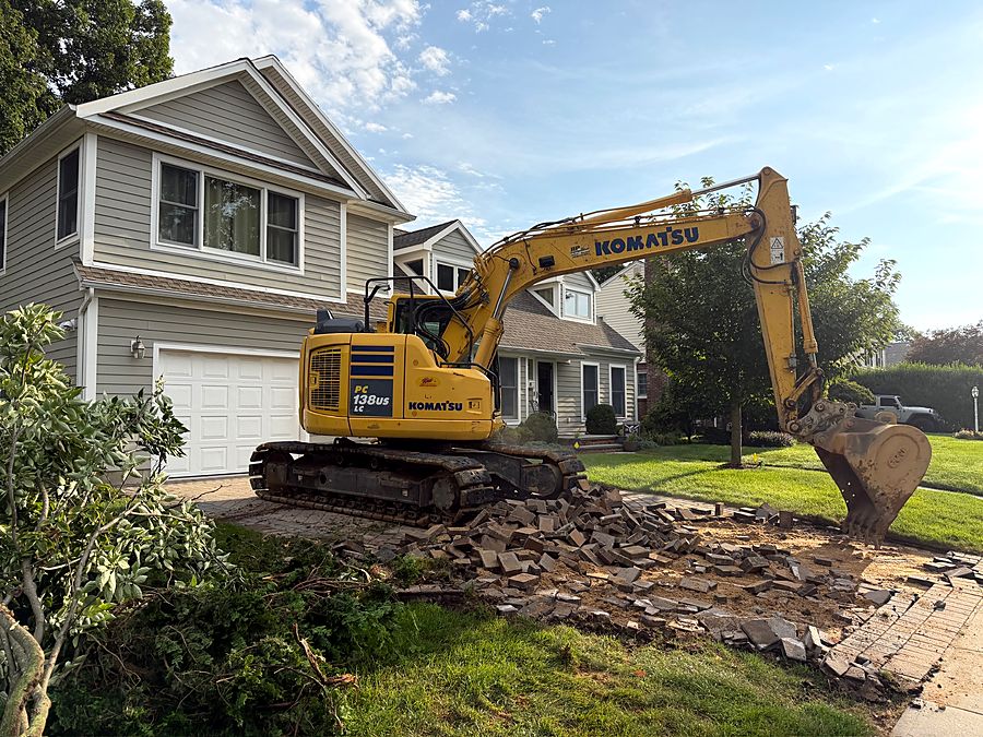 Excavator on site starting to break out the old driveway
