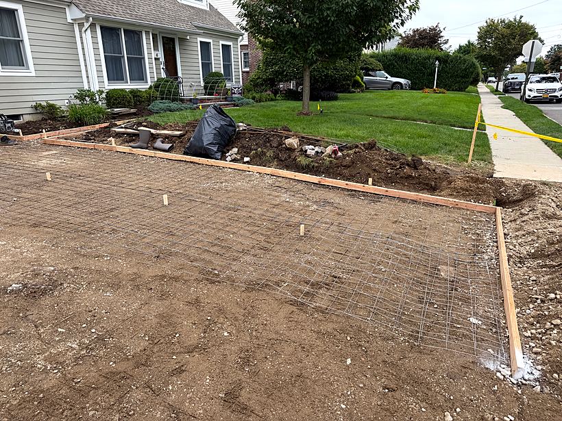Forms and string lines set to establish the new driveway grade