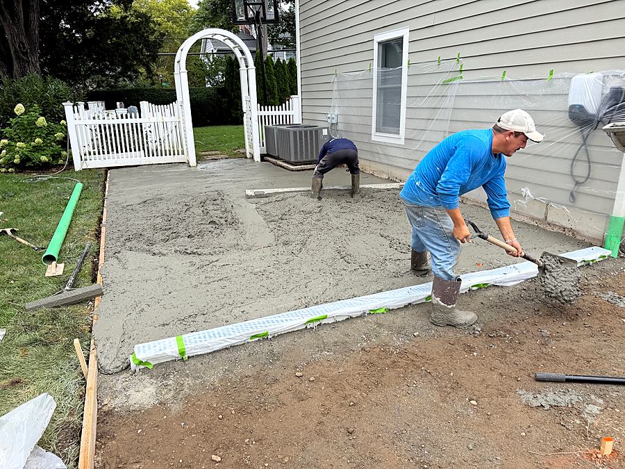 Crew member screeding the base ahead of the concrete pour