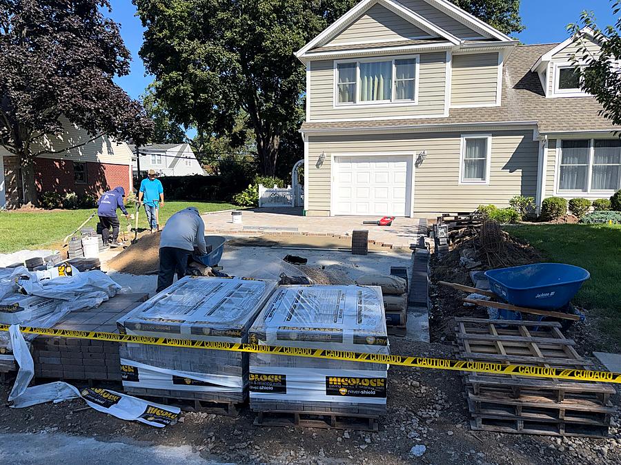 Pallets of paving stones staged on site before installation