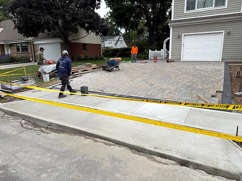 Crew laying the paver field across the new driveway