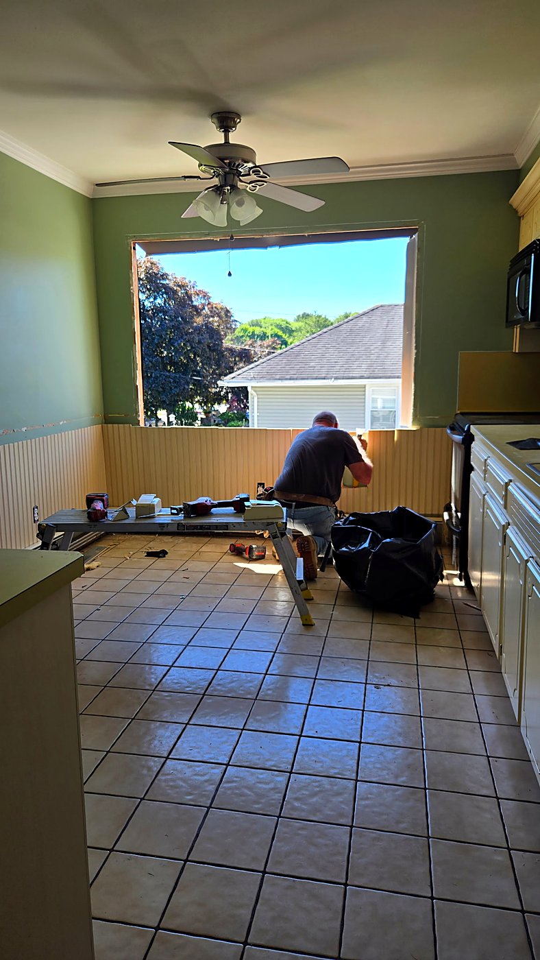 Original kitchen with tile floors and oak cabinets before demolition