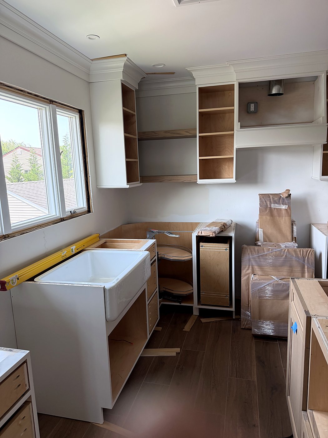 New cabinets and a farmhouse sink base set in the renovated kitchen