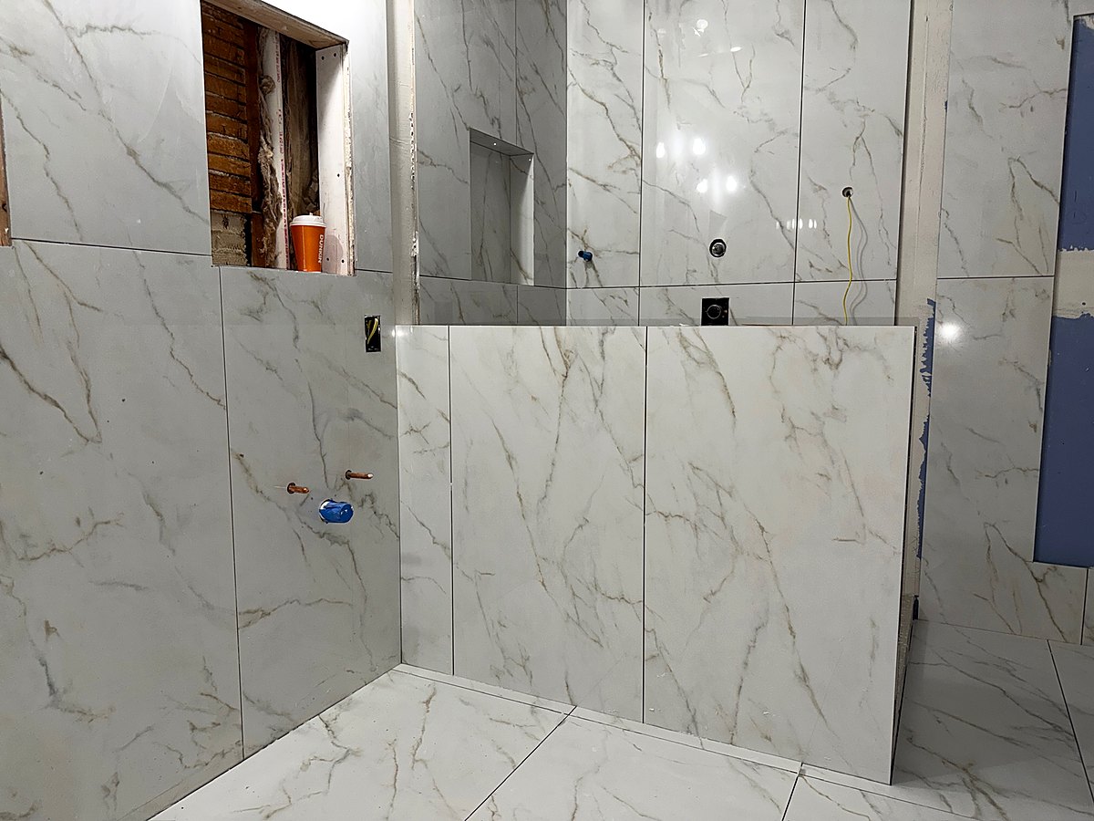 Tiled shower with a recessed niche ready for fixtures
