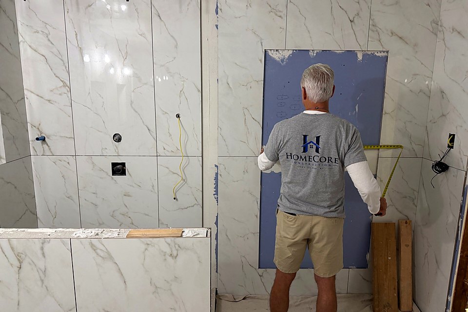 Crew member finishing the last wall ahead of tile