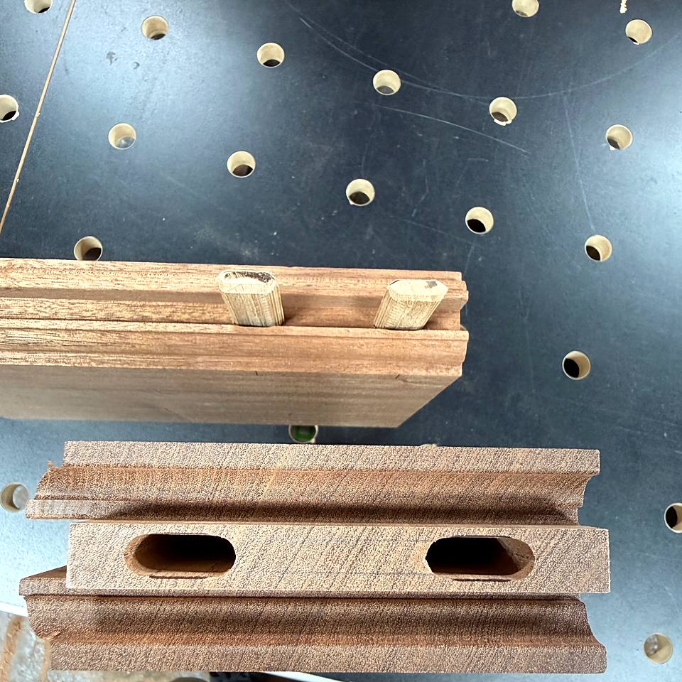 Door rails with machined mortises ready for assembly on a shop bench