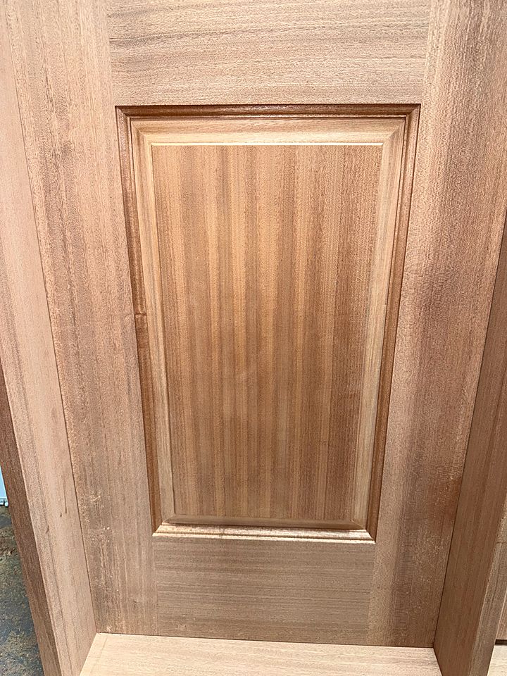Raised panel set into a solid wood door frame in the shop