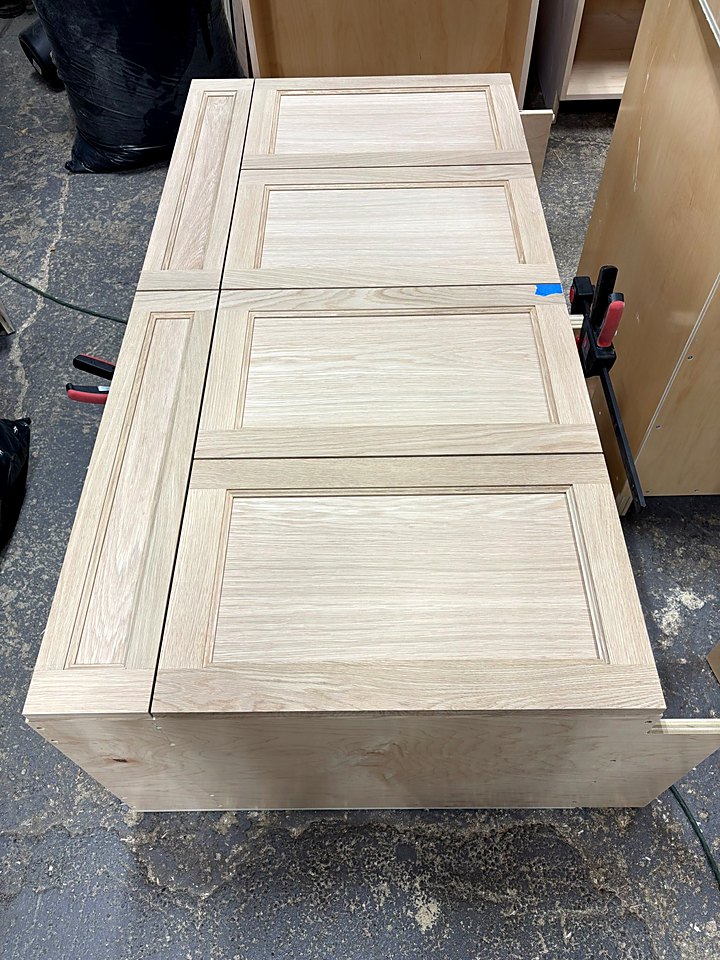 Raised panels set on a cabinet box during assembly