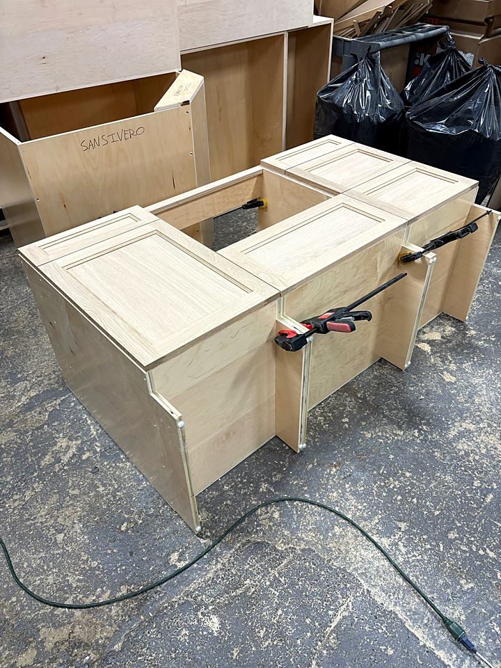 Cabinet box clamped up during glue-up on the shop floor
