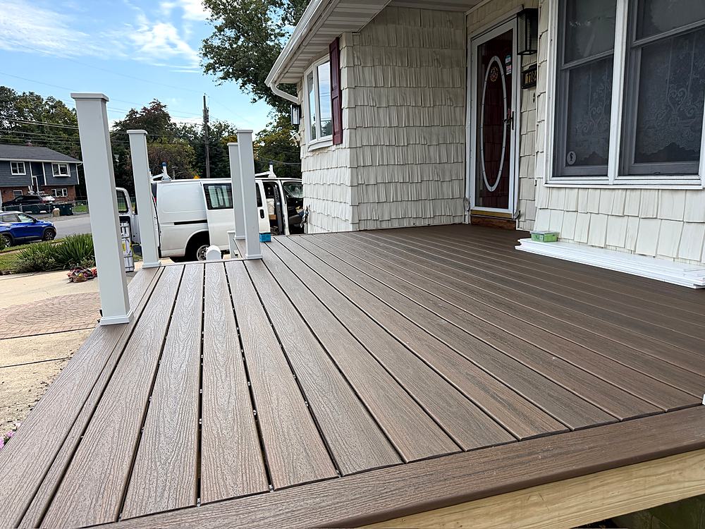 Finished composite deck surface running the width of the porch