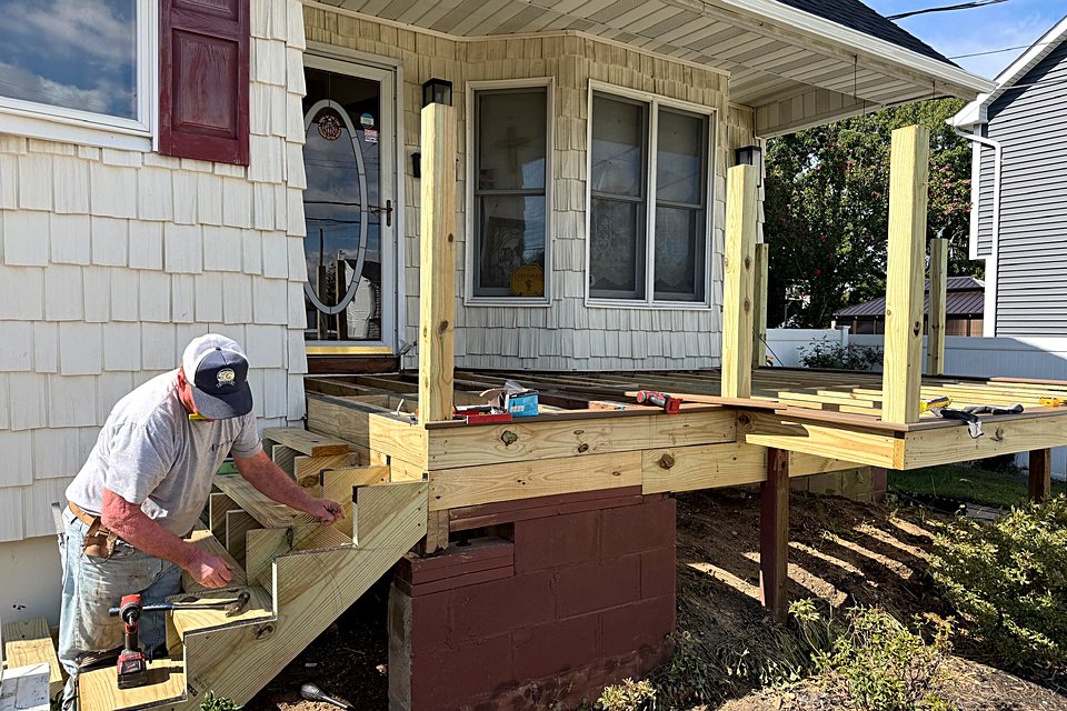 Crew member framing the new porch stairs