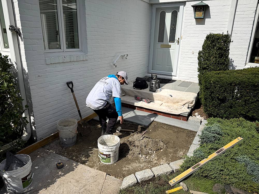 Crew laying bluestone across the new front entry