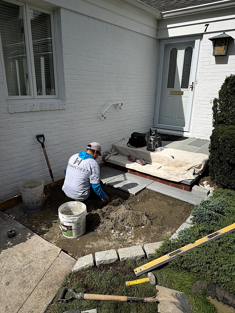 Crew fitting bluestone around the front entry steps