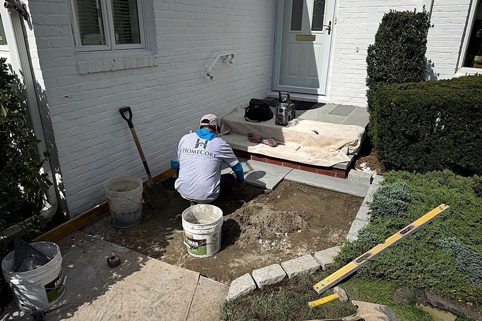 Crew member prepping the base for the new entry walkway
