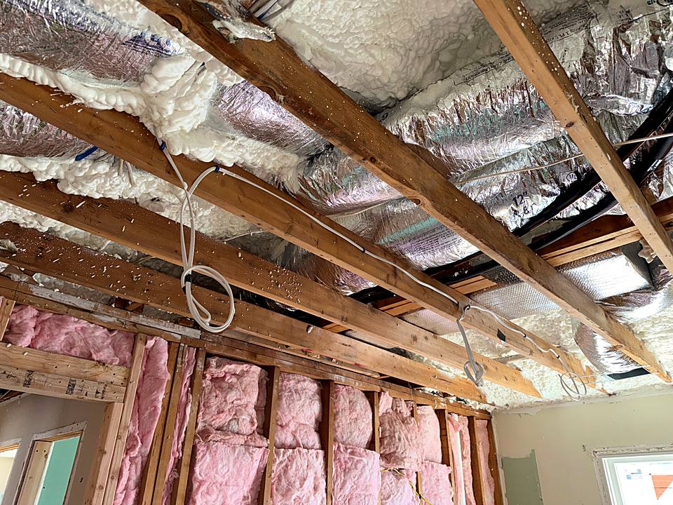 Spray foam insulation between the rafters above newly insulated walls