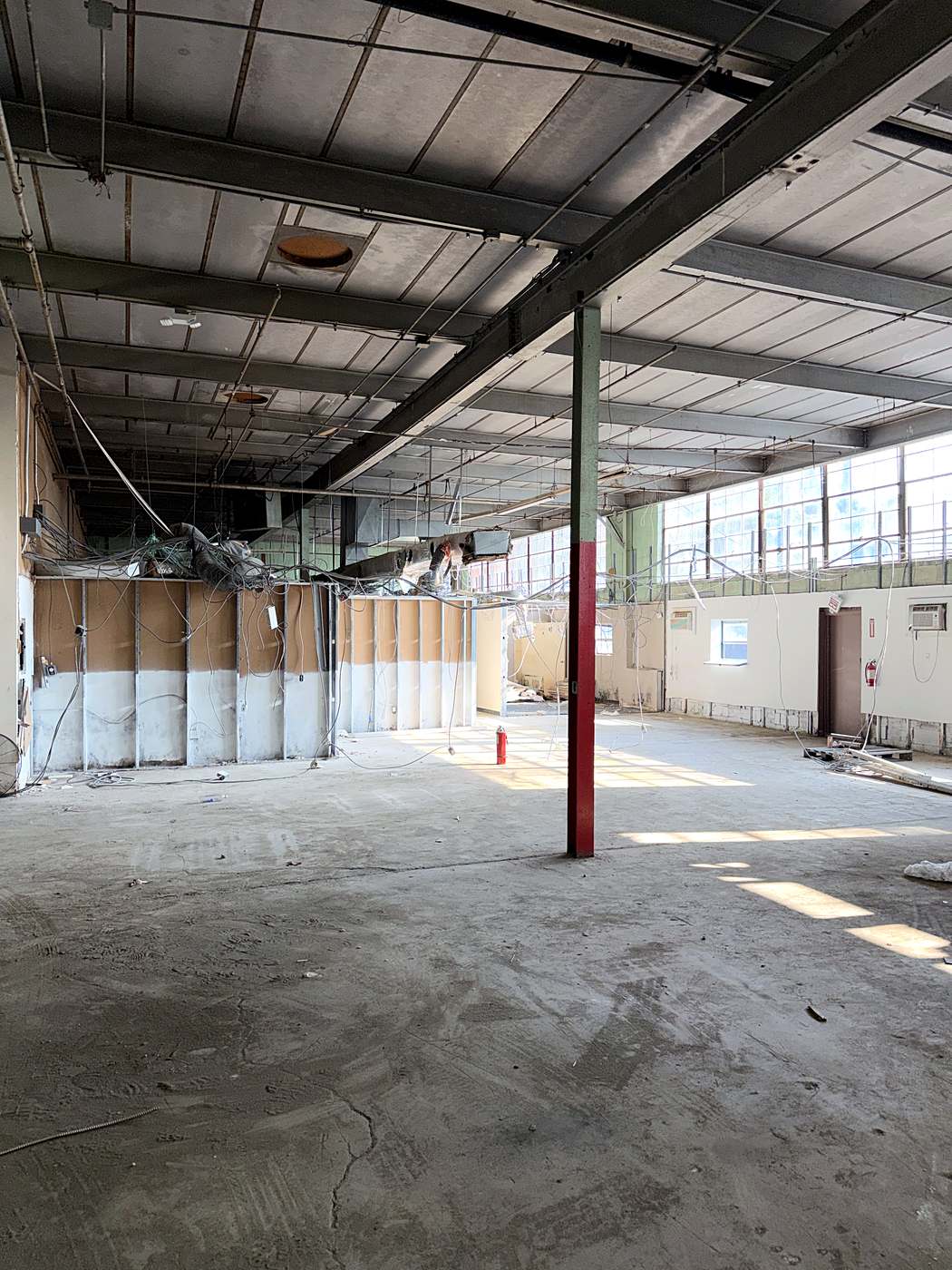 The original commercial interior with partitions and a dropped ceiling still in place