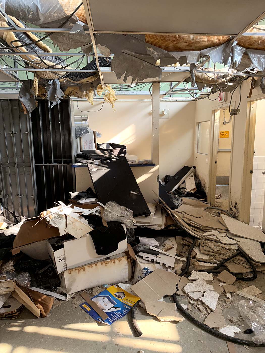 Demolition underway with the dropped ceiling and ductwork pulled down