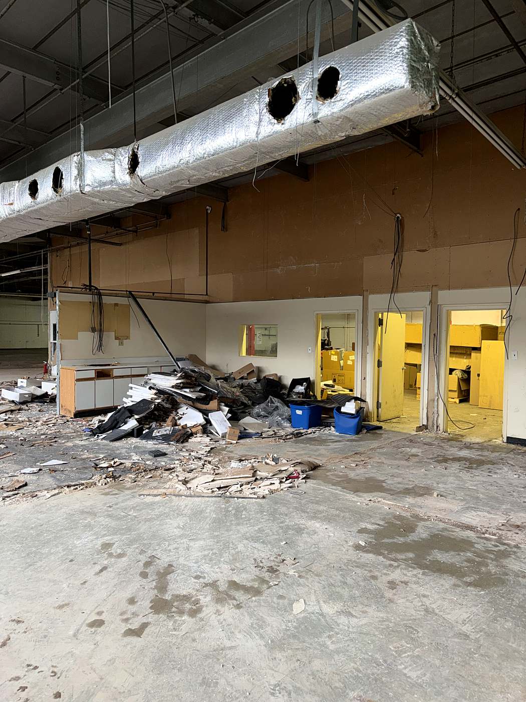 Demolition debris staged along the old service counters for removal