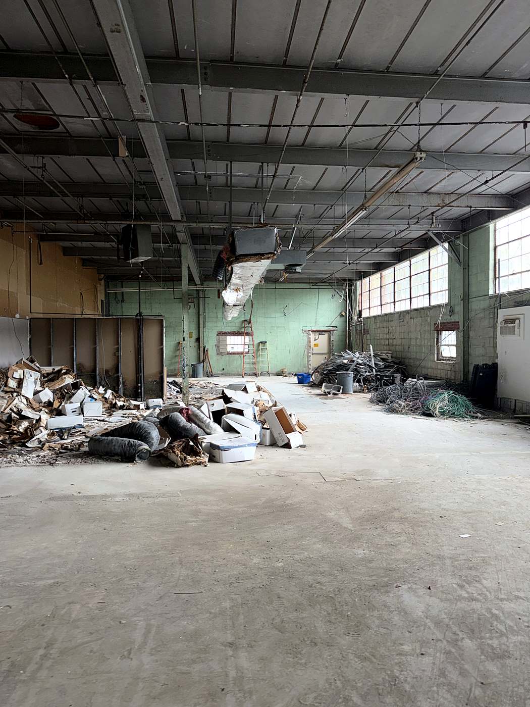 The open floor cleared back to the block walls and steel structure