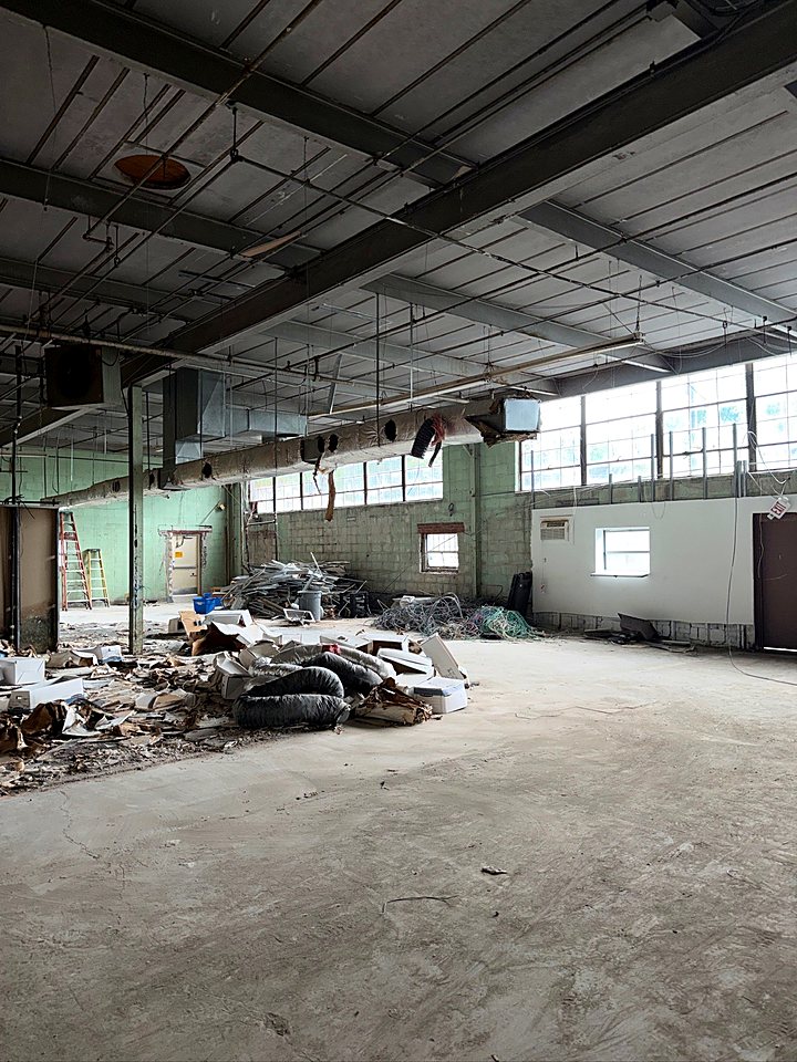 Open floor with the last demolition debris piled for removal