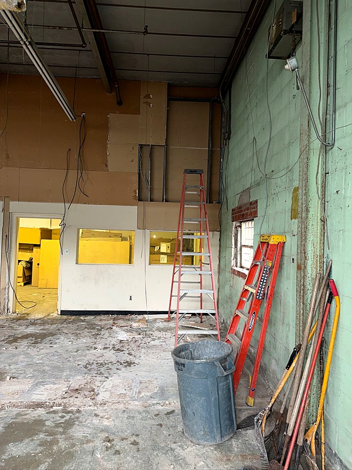 Ladders set along the back wall as the old offices come out