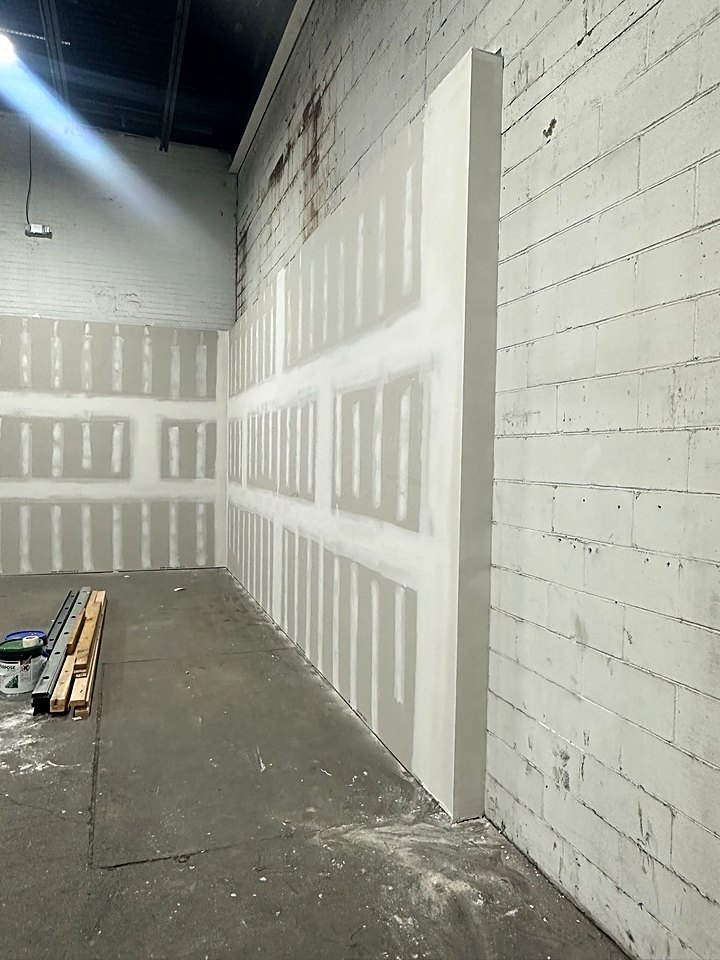 New drywall hung and taped over the block walls